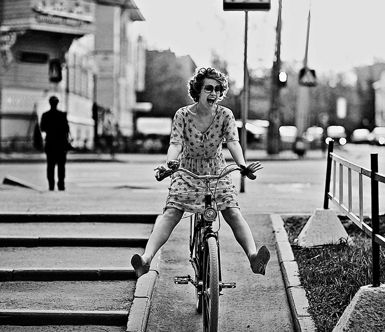 woman from the 50s riding a bike and having fun